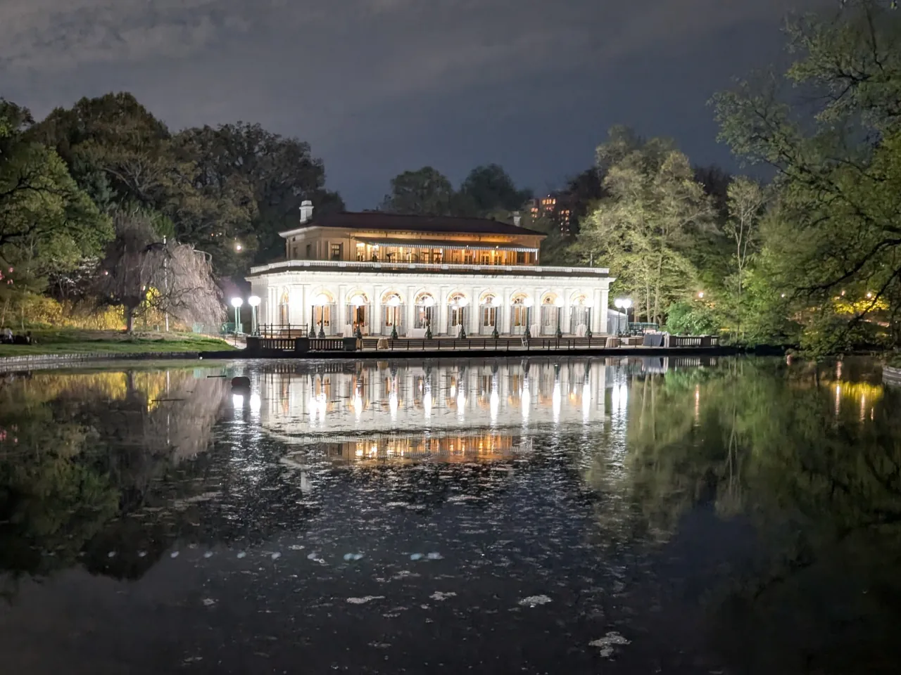 Boathouse reflecting off a lake